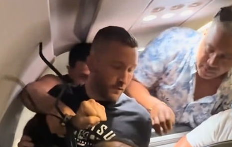 Nightmarish moment Frontier flight passengers had to restrain madman who tried to open jet’s doors in mid-air and burst into cockpit